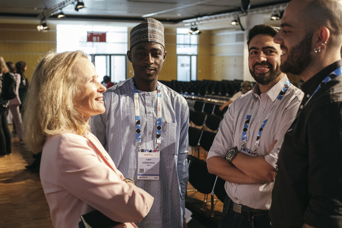 amfAR Mathilde Krim fellow Dr. Gabriel Duette and others speak with outgoing International AIDS Society president Dr. Sharon Lewin at the International AIDS Conference in Munich, Germany.